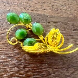 Vintage plated brooch with vines and engraved leaves.